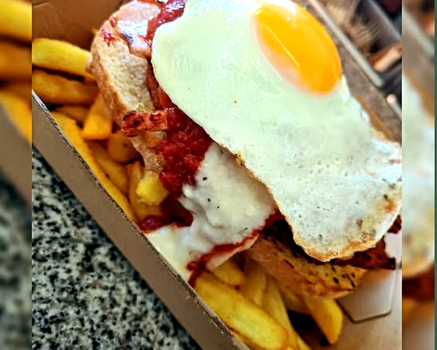 JL Parmy's loaded chicken parmy with egg, sauce, cheese and chips